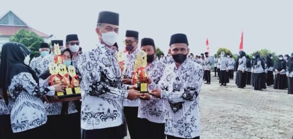 Bupati Natuna, Menyerahkan Piala Pemenang Lomba Kepada Guru